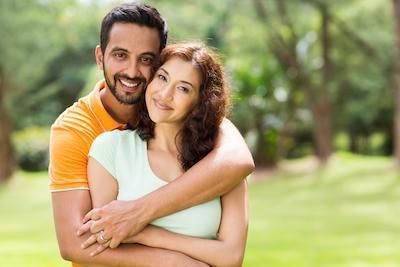man hugging woman from behind 