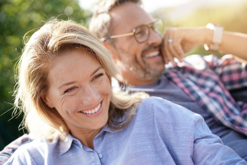 woman smiling with man laughing in background