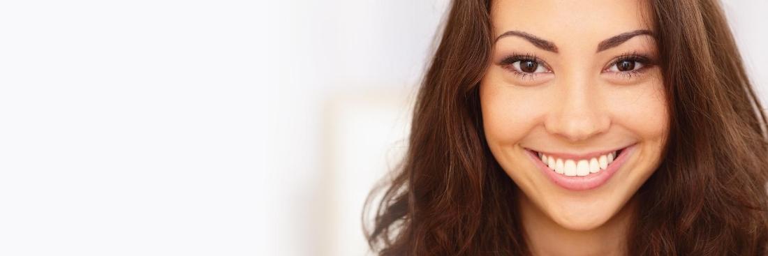 Woman smiling after getting dental crowns in Burnaby, BC