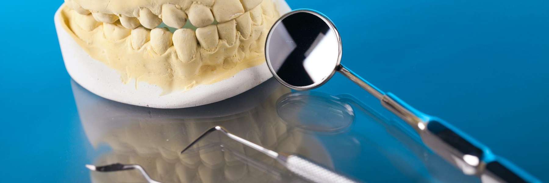 A picture of tooth extraction tools and a dental crown in Kingsway,Burnaby