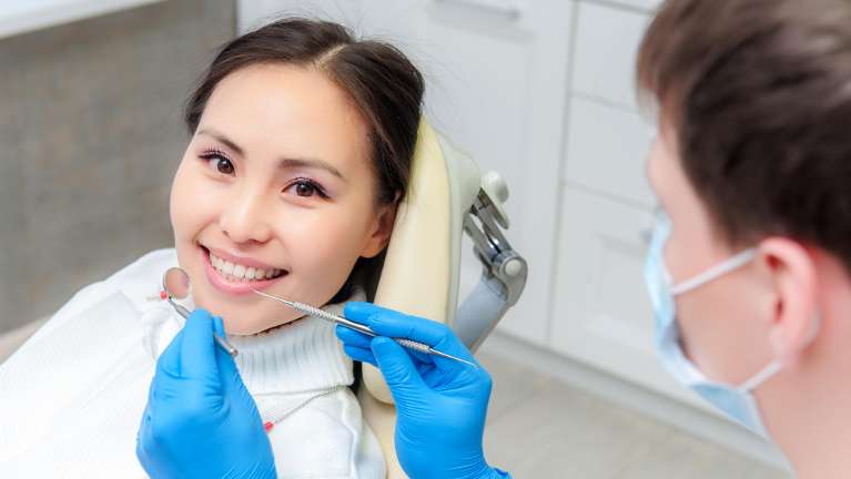 A asian patient getting ready for teeth cleaning in Burnaby, BC