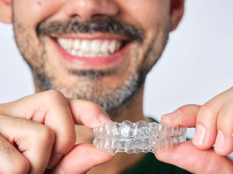 A Man holding Invisalign in Burnaby, BC