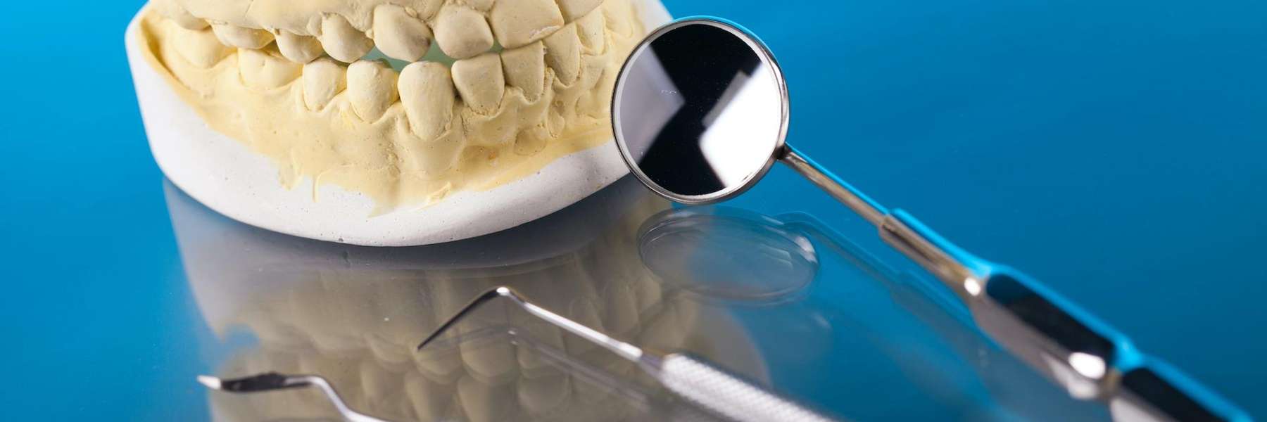 An illustration of a dental crown and tooth extraction equipment at Central Park Dental Clinic
