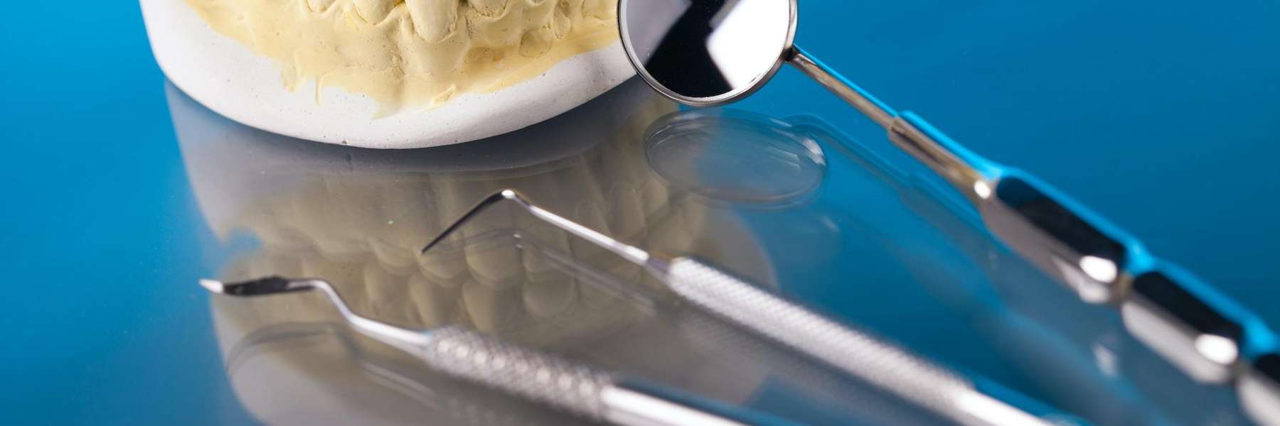 A picture of teeth extraction tools and a dental crown in Kingsway, Burnaby